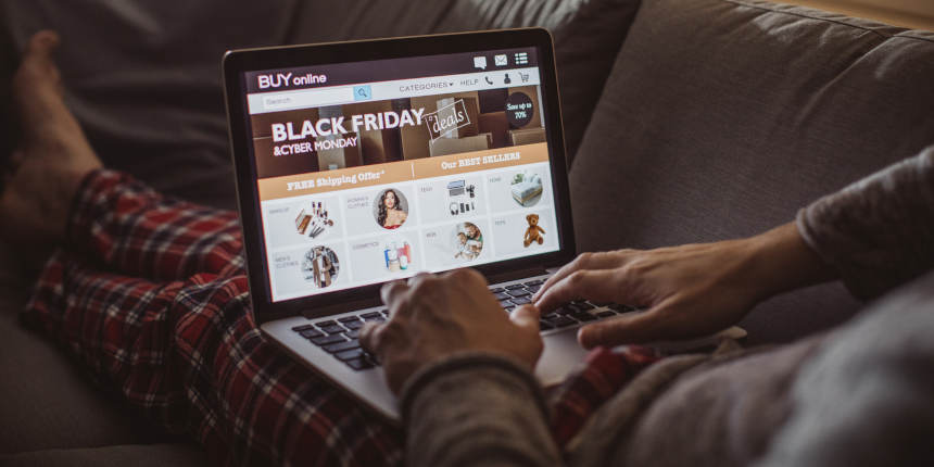 Man shopping online for Black Friday sales on his laptop