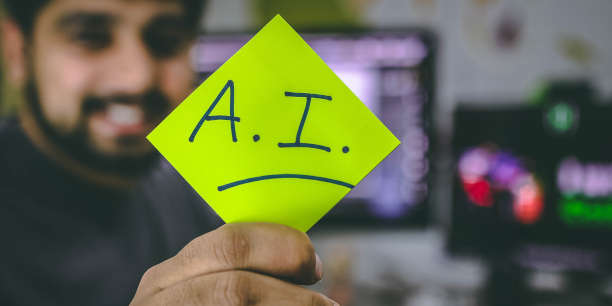 Man holding handwritten note that says "A.I."