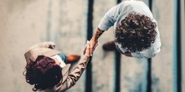 Bird's eye view of two people shaking hands.
