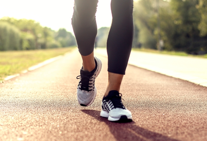 Photograph of lower legs jogging along an outdoor running track