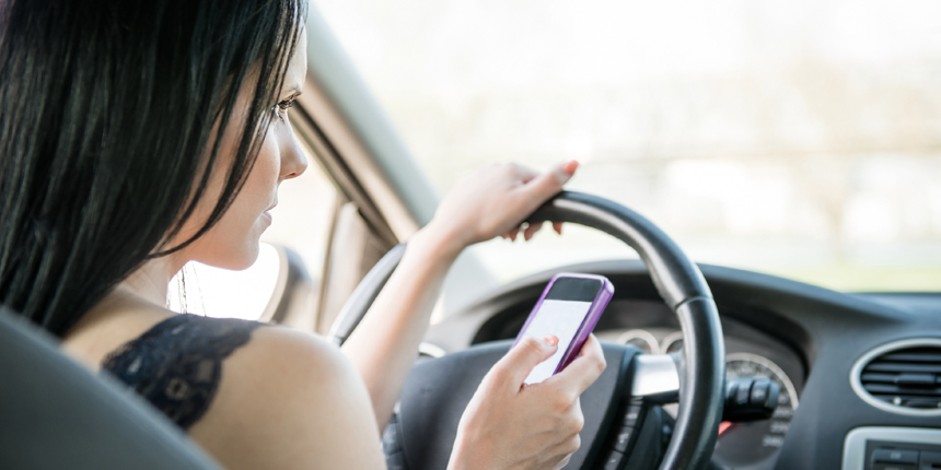 Woman using smartphone while driving