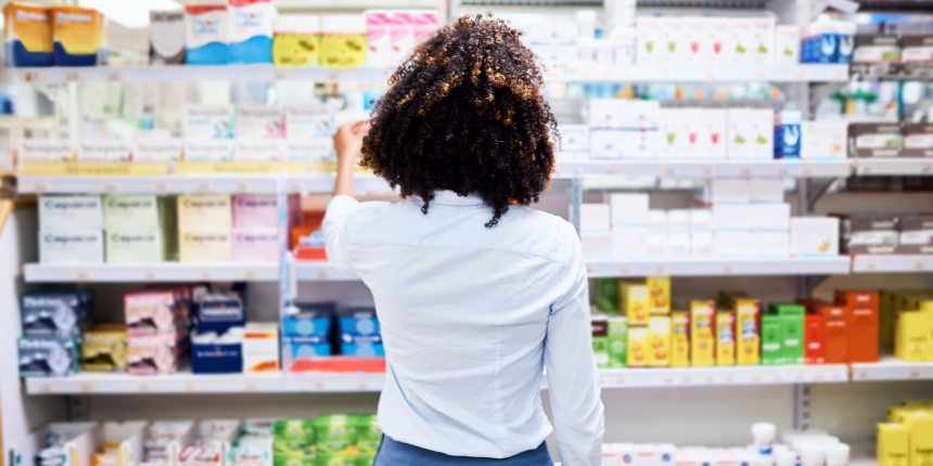 Rearview shot of a young woman looking at products in a pharmacy