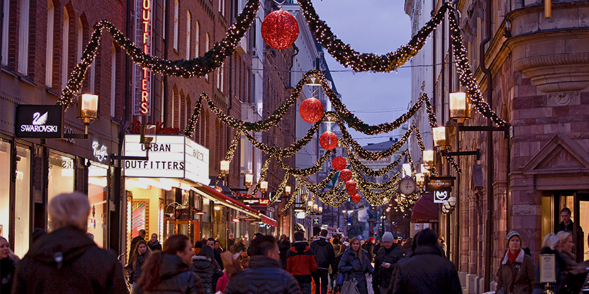 A busy shopping street adorned with festive decorations