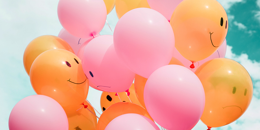 Colorful balloons with smiling faces.