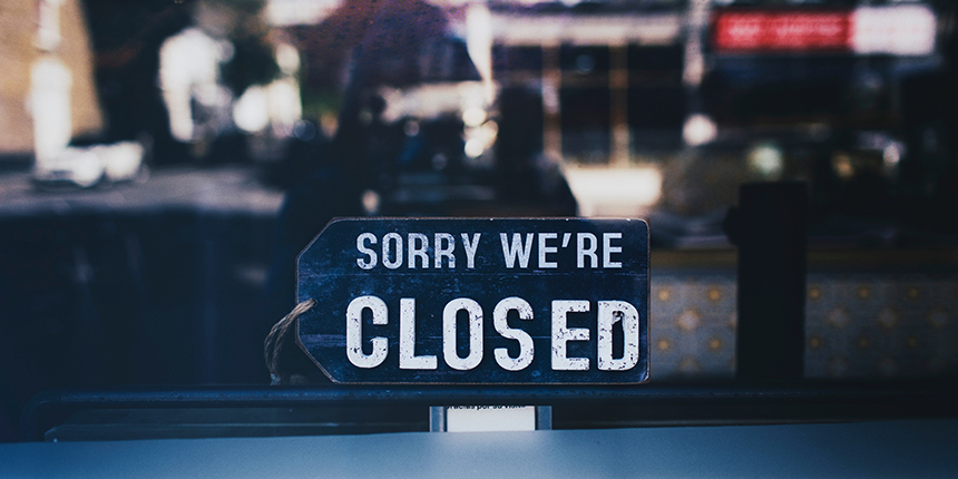 Closed sign in the window of a business.