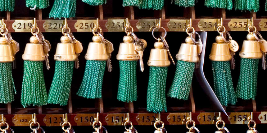 Old fashioned hotel reception with rows of keys with green tassles