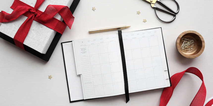 Holiday stationery laid out on a white surface