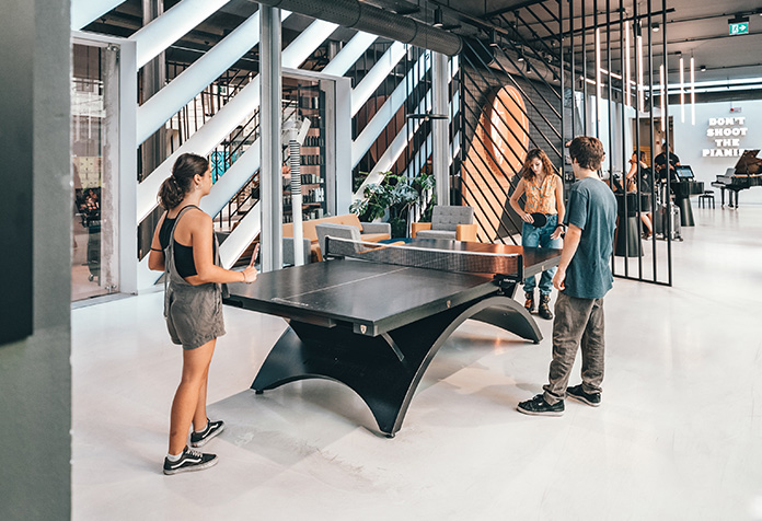 Shoppers playing ping pong in a store