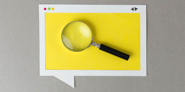 Magnifying glass in the paper browser window frame.
