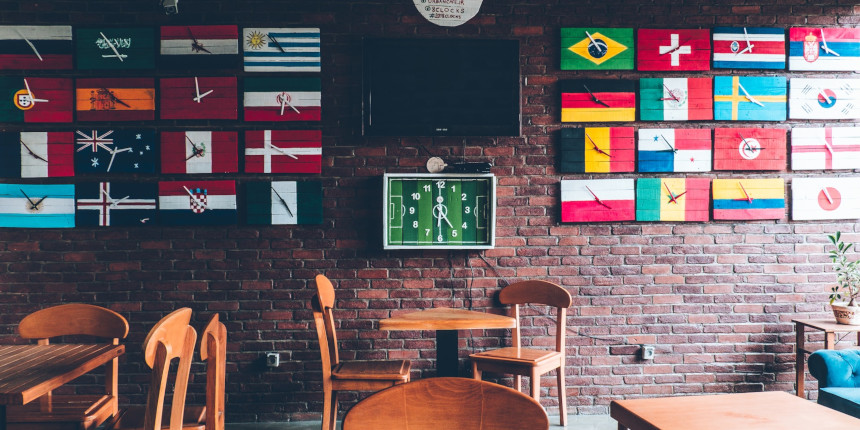 Flags of World Cup nations on a restaurant wall.