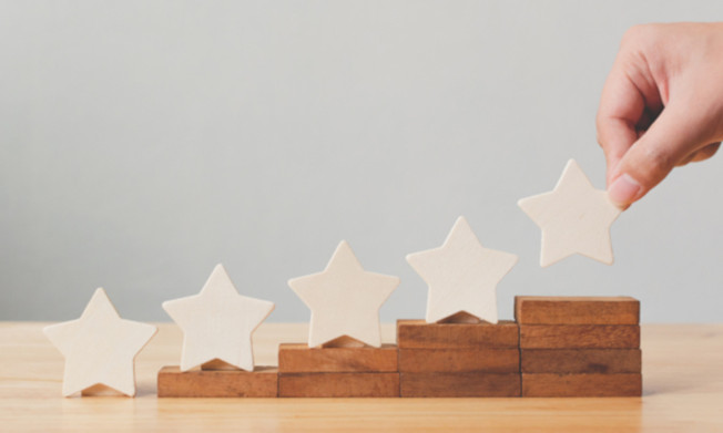 Five stars arranged on wooden steps.
