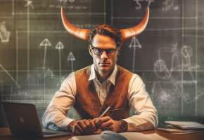 A man with bull horns sits at a desk with a laptop, in front of a chalkboard covered with scientific diagrams.