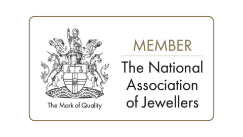 "Member of The National Association of Jewellers" emblem featuring a crest with the motto "Concordia Integritas Industria" and "The Mark of Quality" below.