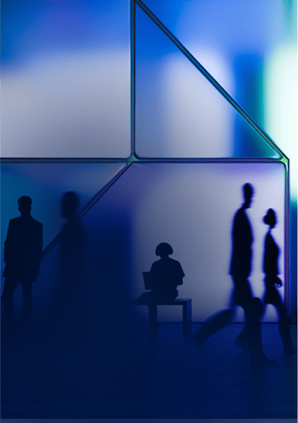 Silhouettes of people walking and sitting in front of a blue-toned, abstract geometric backdrop.