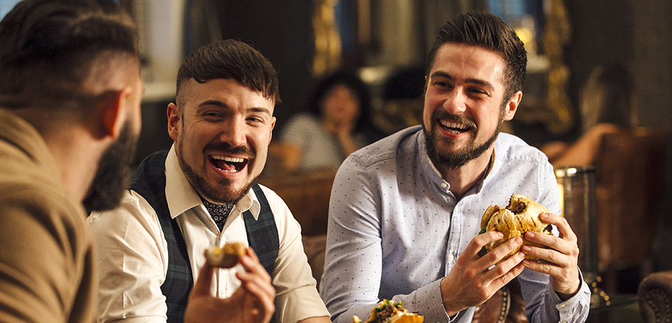 Three friends enjoying hamburgers together