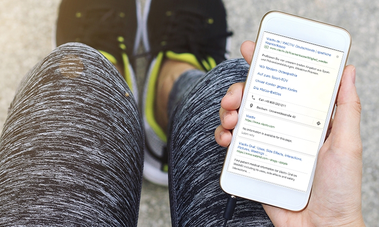 Point-of-view shot of a smartphone showing paid and organic search results for VIACTIV