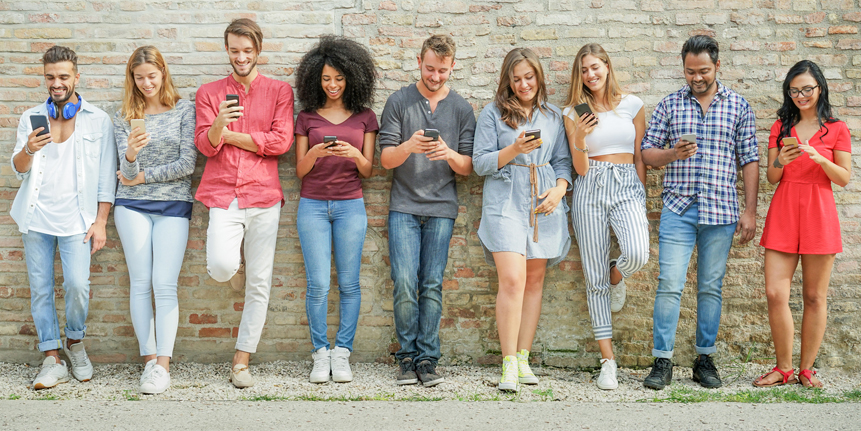 Group of millennials on their mobile phones