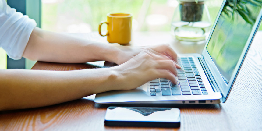 hands typing on laptop