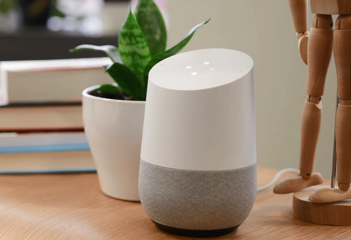 Google Home device on a bamboo side table
