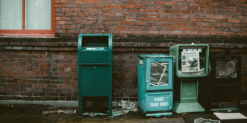 Mailbox and newspaper boxes on the street.