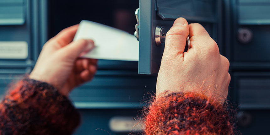 Close up of hands opening a mailbox