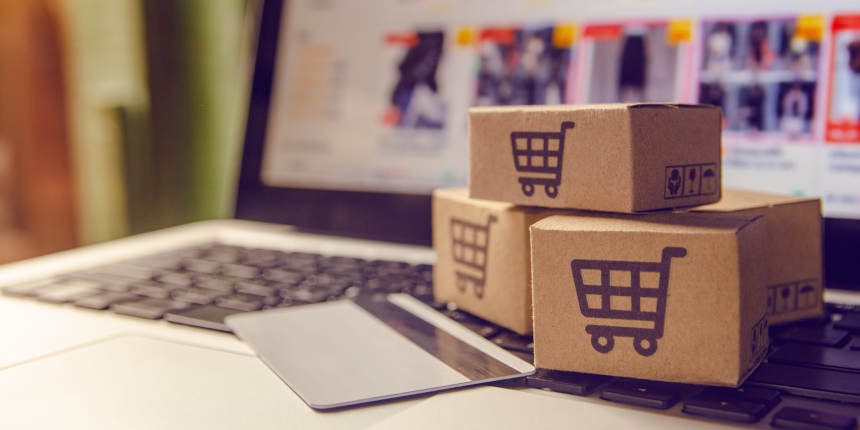 Shopping online concept - Shopping service on The online web. with payment by credit card and offers home delivery. parcel or Paper cartons with a shopping cart logo on a laptop keyboard