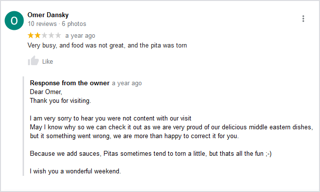 A negative Google review with a response from the business owner