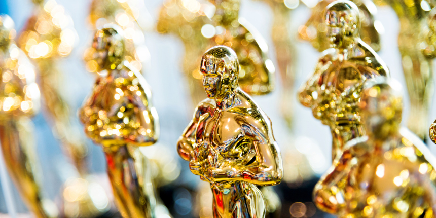 Large group of golden award statues in a shop for sale at Universal Studios Singapore