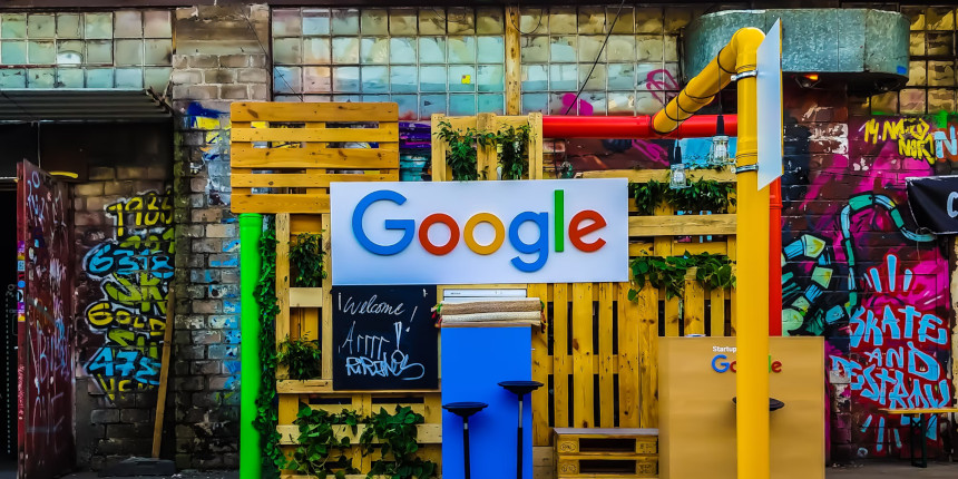Google logo in a colorful outdoor setting.