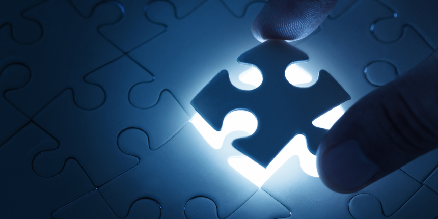 Business concept, male hand putting missing piece of jigsaw puzzle with copy space